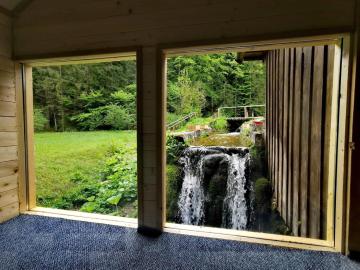 Wooden house with a waterfall