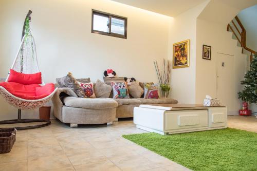 a living room with a couch and a green rug at Mysig in Luodong