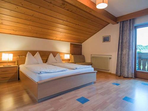 a bedroom with a large bed and a large window at Residence Rebgut in Tesimo