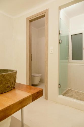 a bathroom with a sink and a mirror at Villa Elina suites and more in Agios Stefanos