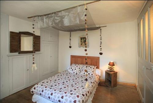 a bedroom with a bed with a canopy at Le Gîte des Faucons in Faucon-de-Barcelonnette