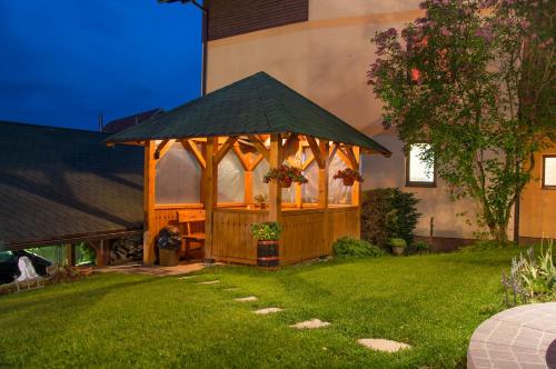 a gazebo in the yard of a house at Apartments Josipovic in Zlatibor