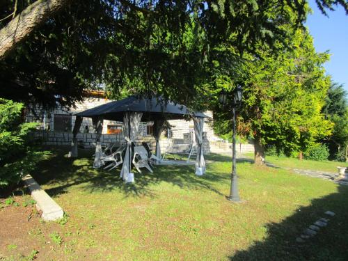 a gazebo in a park with a tree at Fouettara in Firminy
