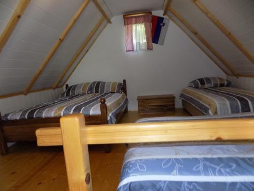 a room with two beds in a attic at Holiday Home Na planini in Tolmin