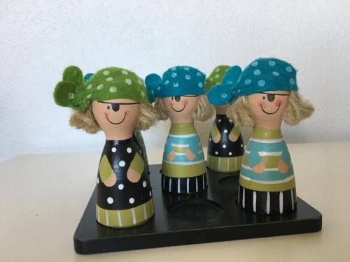 a group of four dolls on a black shelf at Casa Aurora in Aalborg