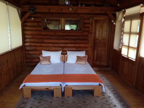 Un dormitorio con una cama en una cabaña de troncos en Holiday home "Aida", en Visoko