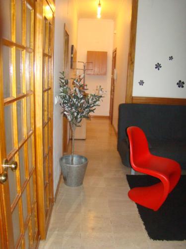 a living room with a couch and a red chair at Tejo Apartment in Lisbon