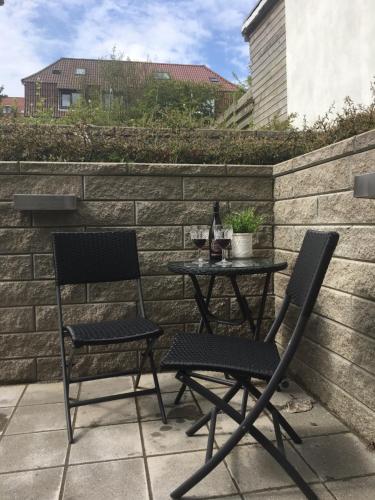 two chairs and a table on a patio at Casa Aurora in Aalborg