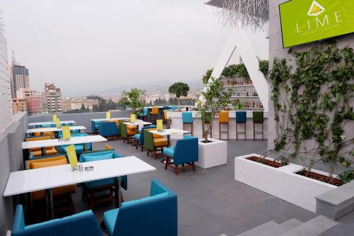 a restaurant with tables and chairs on a roof at Urban Central Suites - Beirut in Beirut