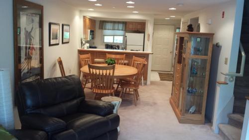 a living room and kitchen with a table and chairs at Lovely Townhouse with Views in Lincoln