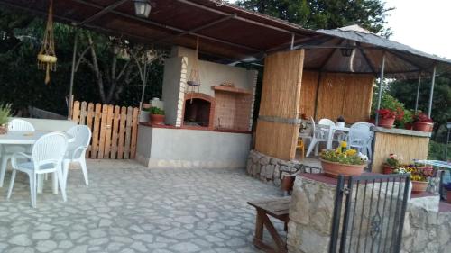 a patio with a table and chairs and an umbrella at B&B La Vecchia Scuola in Sonnino