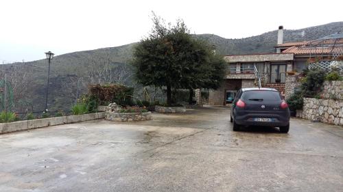 a small car parked in a parking lot at B&B La Vecchia Scuola in Sonnino