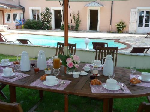 a wooden table with food and drinks on top of it at La Maison du Parc in Yzeron