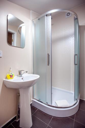 a bathroom with a sink and a shower at Apartments near Deribasovskaya in Odesa