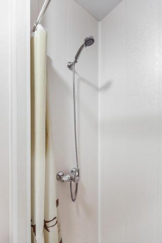 a shower in a bathroom with white walls at Apartments near Deribasovskaya in Odesa