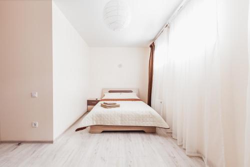 a bed in a room with white walls at Apartments near Deribasovskaya in Odesa