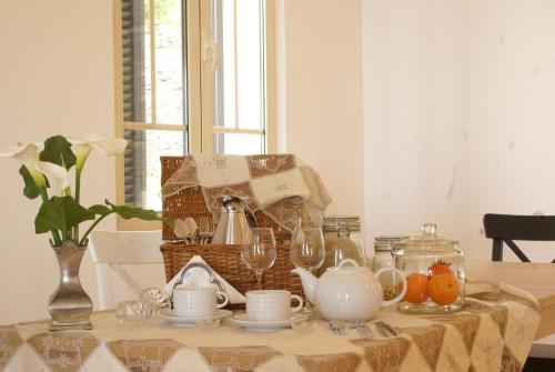 a table with a tea set on top of it at Quinta Paços do Lago in Funchal
