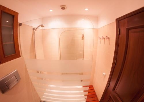 a bathroom with a walk in shower next to a door at Just Estoril in Estoril