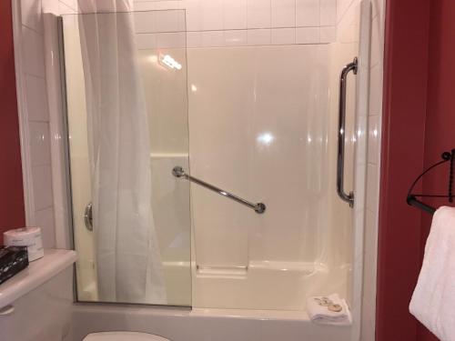 a bathroom with a shower with a glass door at The Inn at Tough City in Tofino