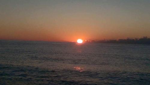 a sunset over a large body of water at Oriental Hotel in Taimali