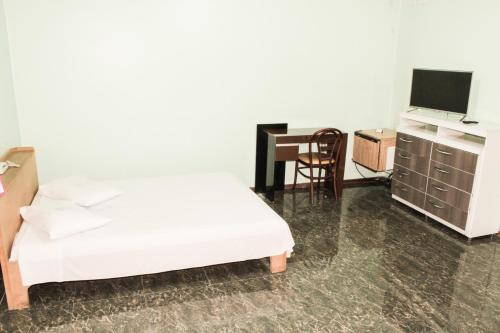 Ένα ή περισσότερα κρεβάτια σε δωμάτιο στο Cumbipar King Hotel