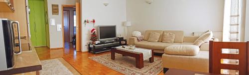 a living room with a couch and a tv at Apartment 31 in Pristina