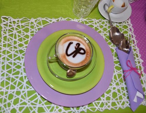 a cup of coffee on a plate on a table at up in Carosino