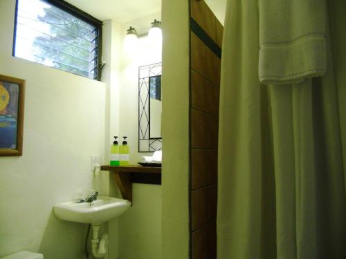 a bathroom with a sink and a toilet and a window at Creekside Oasis in Punta Gorda