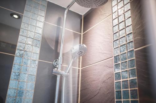 a shower with a shower head in a bathroom at Ferienwohnung Alpi in Garmisch-Partenkirchen