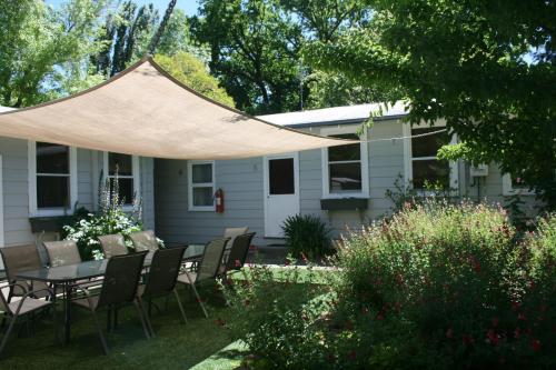 a patio with a table and chairs under a tent at Elm Lodge Bright in Bright