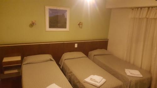 Una pequeña habitación con dos camas. en Hotel Compostela, en Mar del Plata