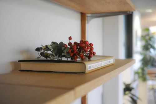 a book with a plant on top of a counter at sararaso in Kanazawa