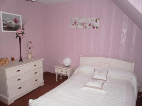 a bedroom with a white bed and a dresser at Chambres d'Hôtes Ty Mezad in Séné