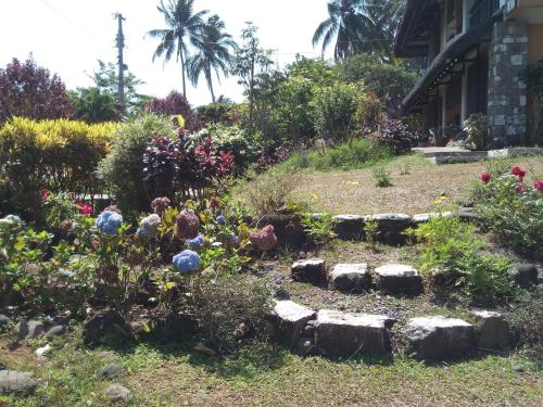 a garden in front of a building at The Duyan House at Sinagtala Resort in Orani