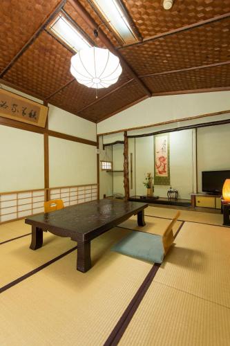 a room with a table in the middle of a room at Ryokan Seifuso in Ōmuta