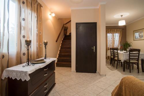a living room with a black door and a dining room at Villa Lina in Pandokrátor