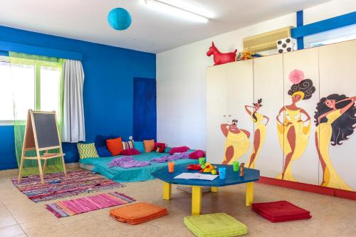 a living room with blue walls and a room with a table at Princess Sun Hotel in Kiotari