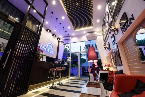 a lobby of a store with a table and chairs at 48 Metro Hotel in Bangkok
