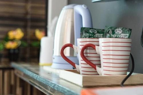 a couple of coffee mugs sitting on a counter at 48 Metro Hotel in Bangkok
