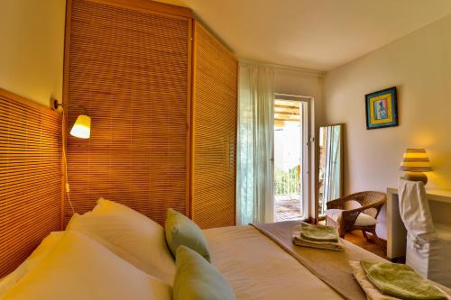 a bedroom with a large bed with a window at Les Chambres d'Hôtes du Grand Mornas in Carry-le-Rouet