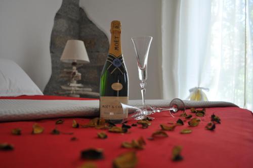a bottle of champagne and a glass on a table at B&B Les Chambres Rooms & Suite in Santa Teresa Gallura