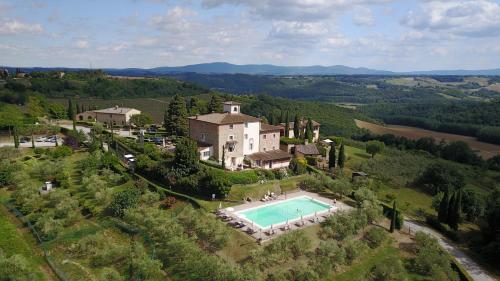 an aerial view of a large house with a swimming pool at Castello di Fulignano in San Gimignano