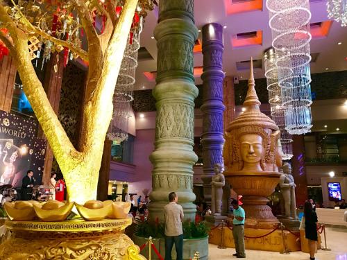 a large fountain in the lobby of a shopping mall at NagaWorld Hotel & Entertainment Complex in Phnom Penh