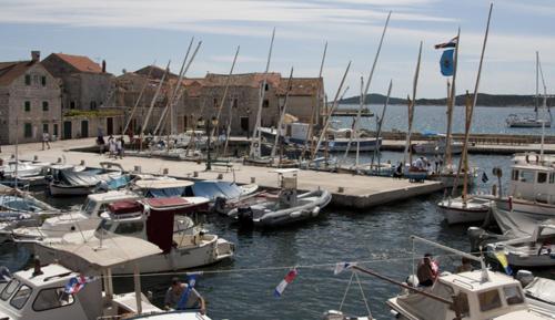 a group of boats docked in a marina at Apartments kod Ilje i Seke in Prvić Šepurine