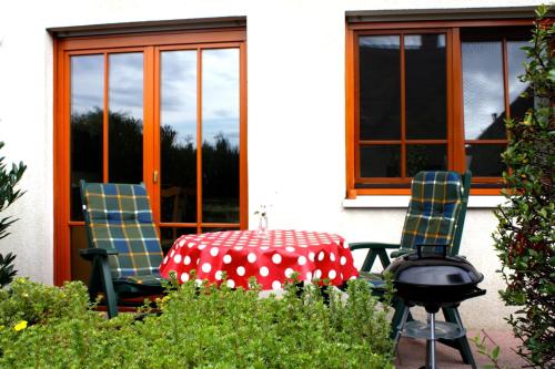 a table and two chairs with a table and a grill at Ferienwohnung Störblick Schwerin in Raben Steinfeld