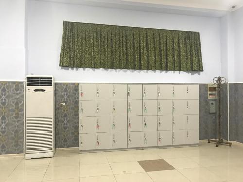 a room with a bunch of lockers and a window at Bereke Hostel in Shymkent