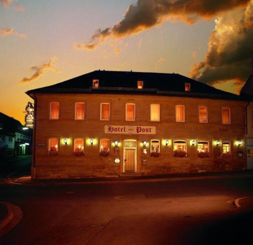 a large building with lights in front of it at Hotel Post in Nordhalben