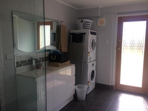 a kitchen with a washing machine and a washer and dryer at Stretton Lane in Townsville