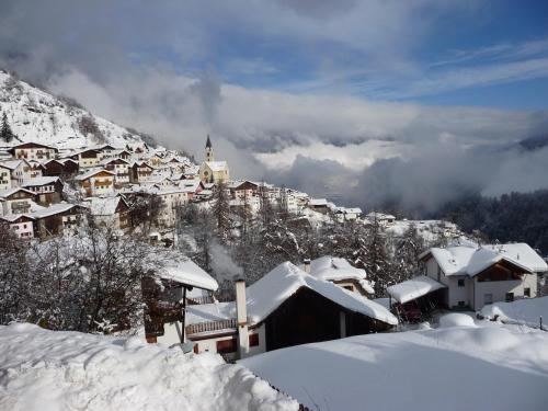 a village covered in snow on a mountain at Hotel Stilfserhof in Stelvio