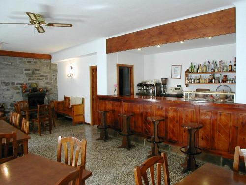 a restaurant with a bar and some tables and chairs at Gabarre in Broto